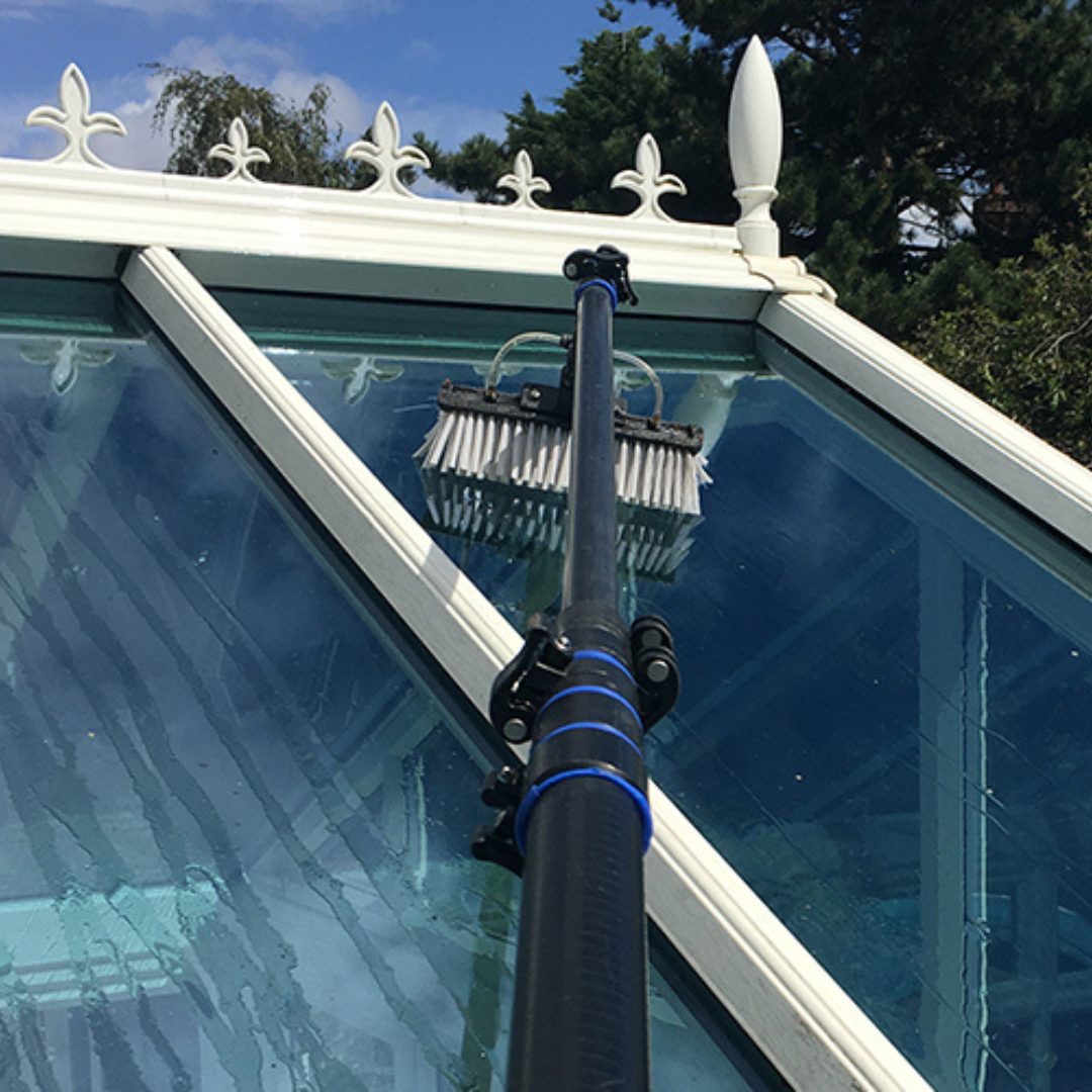 An image of a conservatory roof being cleaned with a water-fed pole
