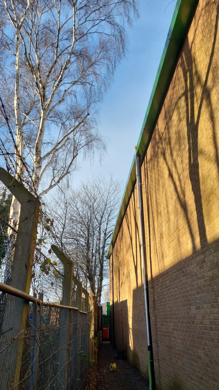 An image of a gutter vaccum clearing the gutters of a warehouse building
